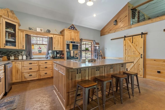 28667 Quarry St, Brook Park, MN 55007 - kitchen with appliances with stainless steel finishes, a barn door, light brown cabinetry, decorative backsplash, and a center island with sink