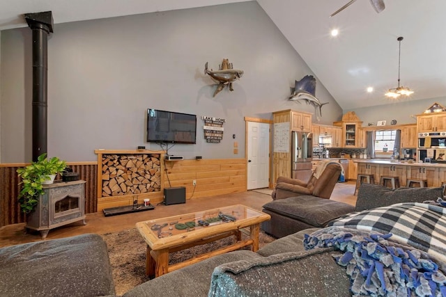 28667 Quarry St, Brook Park, MN 55007 - living area featuring high vaulted ceiling, wainscoting, a wood stove, and wooden walls