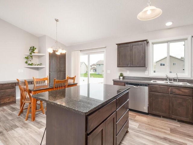 kitchen with a wealth of natural light, light wood-style flooring, a sink, and stainless steel dishwasher