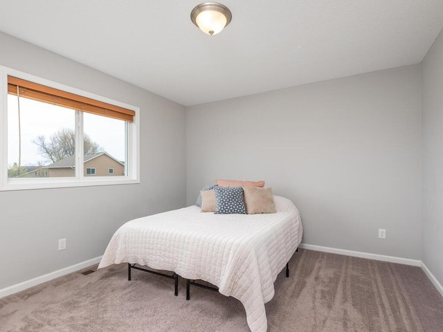 bedroom featuring baseboards, visible vents, and carpet