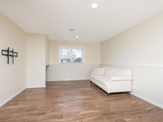 sitting room with recessed lighting, baseboards, and wood finished floors