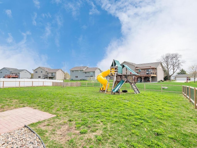 view of yard featuring a playground, a residential view, and a fenced backyard