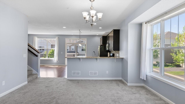 9645 Scott Ln N Unit 32, Brooklyn Park, MN 55443 - kitchen with carpet flooring, freestanding refrigerator, a chandelier, plenty of natural light, and recessed lighting