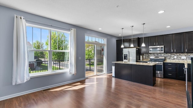 9645 Scott Ln N Unit 32, Brooklyn Park, MN 55443 - kitchen featuring stainless steel appliances, a center island, dark wood finished floors, tasteful backsplash, and recessed lighting