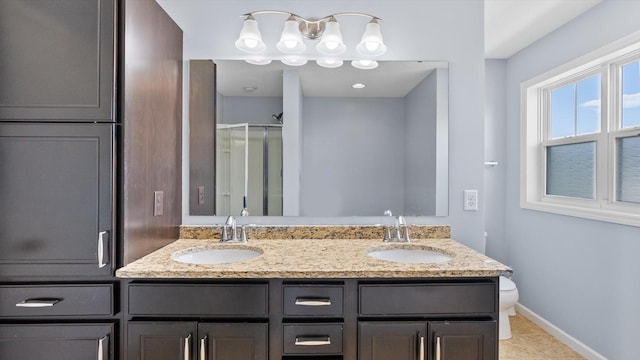 9645 Scott Ln N Unit 32, Brooklyn Park, MN 55443 - bathroom featuring double vanity, a stall shower, baseboards, and toilet