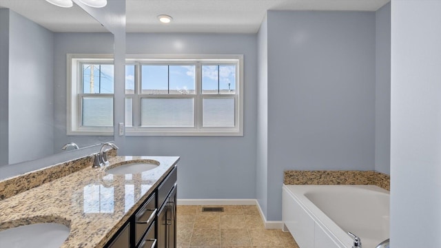 9645 Scott Ln N Unit 32, Brooklyn Park, MN 55443 - bathroom with baseboards, double vanity, a garden tub, and tile patterned floors