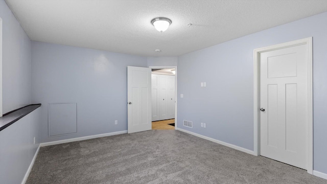 9645 Scott Ln N Unit 32, Brooklyn Park, MN 55443 - unfurnished bedroom featuring carpet, baseboards, and a textured ceiling