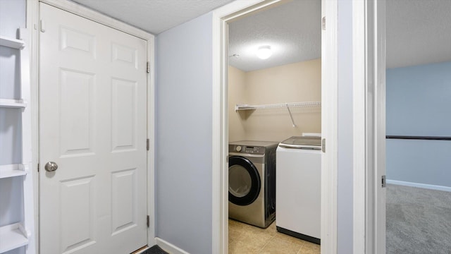 9645 Scott Ln N Unit 32, Brooklyn Park, MN 55443 - clothes washing area with a textured ceiling, baseboards, and washing machine and dryer