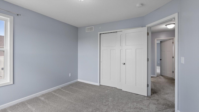 9645 Scott Ln N Unit 32, Brooklyn Park, MN 55443 - unfurnished bedroom featuring carpet, baseboards, and a closet