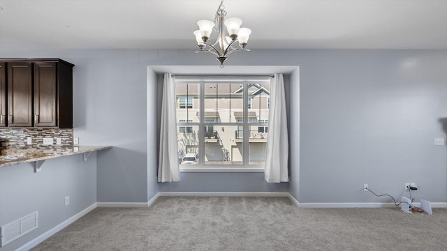 9645 Scott Ln N Unit 32, Brooklyn Park, MN 55443 - unfurnished dining area featuring light carpet, a chandelier, and baseboards