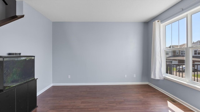 9645 Scott Ln N Unit 32, Brooklyn Park, MN 55443 - unfurnished living room featuring healthy amount of natural light, wood finished floors, and baseboards