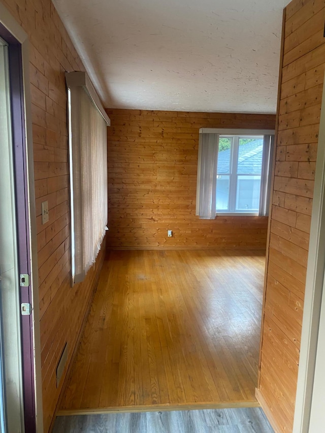 39 Erie St, Aurora, MN 55705 - unfurnished room with wooden walls and wood-type flooring