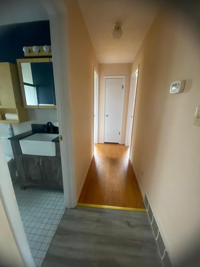 39 Erie St, Aurora, MN 55705 - hallway with baseboards, a sink, and wood finished floors