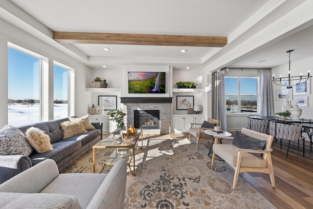 4181 Arbor Dr, Woodbury, MN 55129 - living room with a stone fireplace, beam ceiling, wood finished floors, a notable chandelier, and recessed lighting