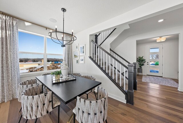 4181 Arbor Dr, Woodbury, MN 55129 - dining space with stairway, baseboards, wood finished floors, and a notable chandelier