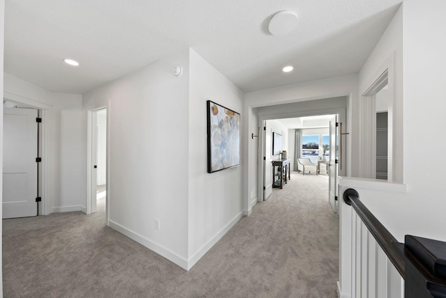 4181 Arbor Dr, Woodbury, MN 55129 - hallway featuring recessed lighting, baseboards, light colored carpet, and an upstairs landing