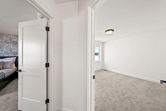 4181 Arbor Dr, Woodbury, MN 55129 - corridor with carpet floors, baseboards, and a textured ceiling