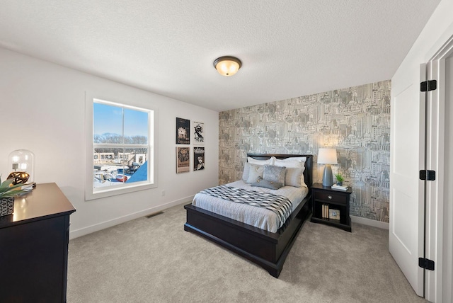 4181 Arbor Dr, Woodbury, MN 55129 - carpeted bedroom with an accent wall, a textured ceiling, baseboards, and visible vents