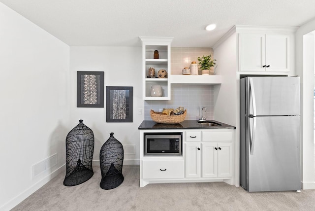 4181 Arbor Dr, Woodbury, MN 55129 - kitchen with a sink, light colored carpet, dark countertops, and appliances with stainless steel finishes