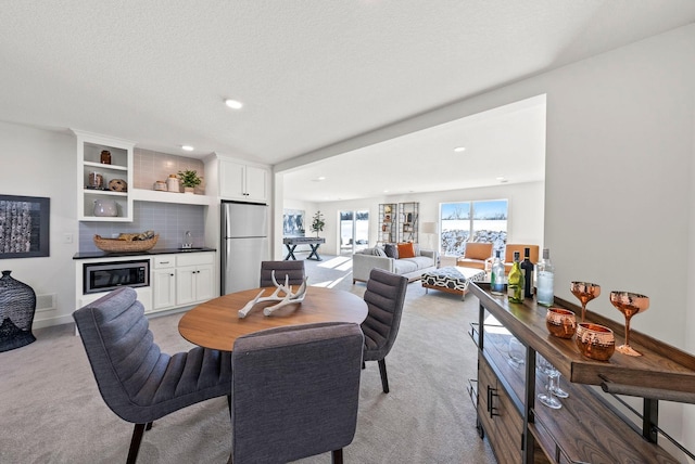 4181 Arbor Dr, Woodbury, MN 55129 - dining area featuring a dry bar, a textured ceiling, recessed lighting, and light colored carpet