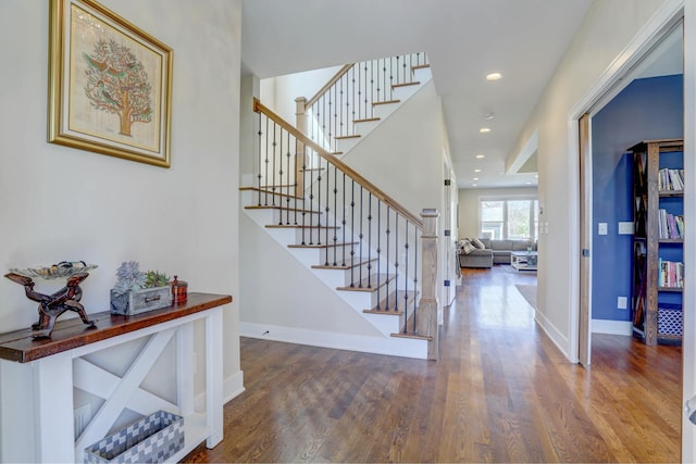 stairway featuring recessed lighting, baseboards, and wood finished floors