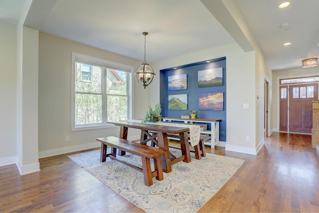 dining area with recessed lighting, wood finished floors, baseboards, and a notable chandelier