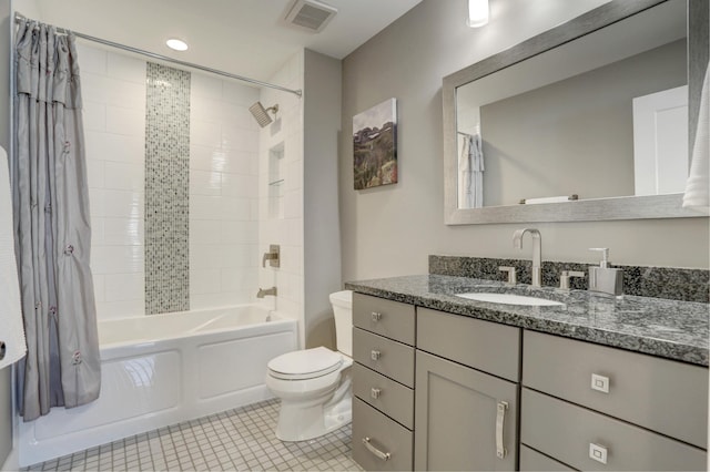 bathroom featuring toilet, shower / bath combo with shower curtain, vanity, visible vents, and tile patterned floors