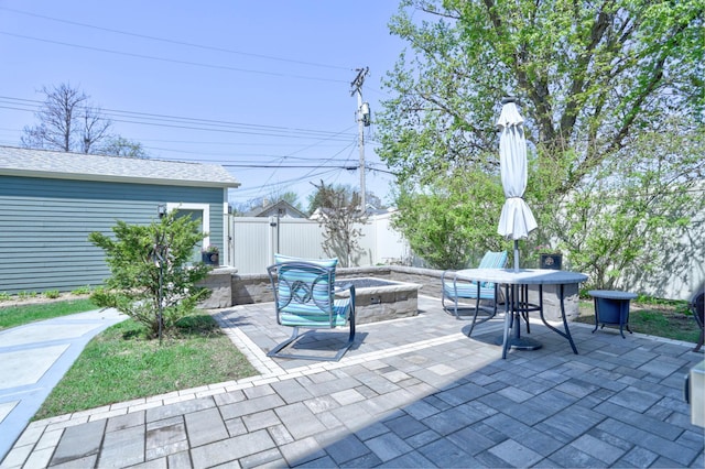 view of patio with a fire pit and fence