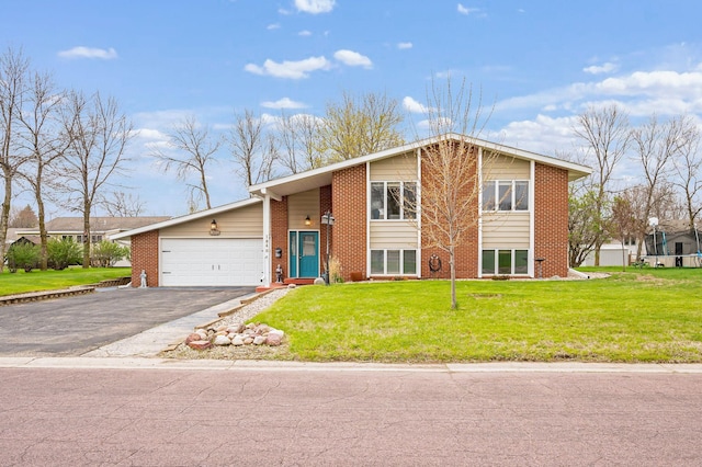 view of front of house with an attached garage, a front yard, aphalt driveway, and brick siding