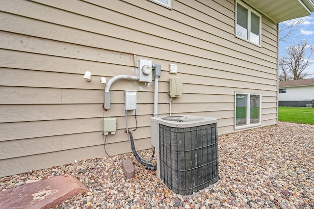 exterior details featuring electric meter and cooling unit