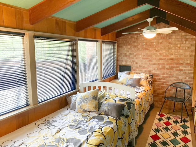 bedroom featuring wooden walls, lofted ceiling with beams, and brick wall