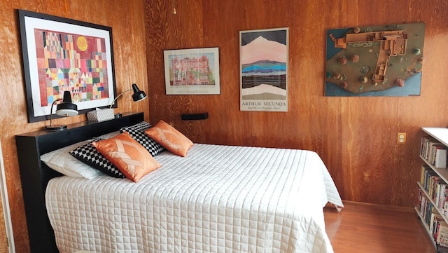 bedroom featuring baseboards and wood finished floors
