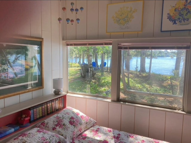 bedroom with a decorative wall and multiple windows