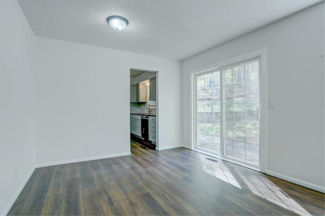 2401 Brookview Dr, Burnsville, MN 55337 - unfurnished living room with dark wood-style flooring, baseboards, and a textured ceiling