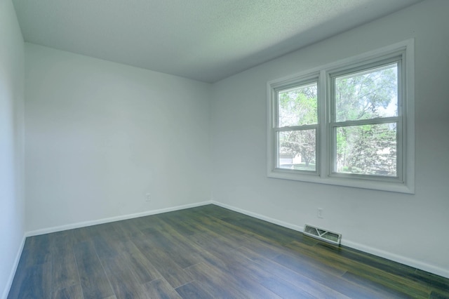 2401 Brookview Dr, Burnsville, MN 55337 - unfurnished room with baseboards and dark wood-type flooring