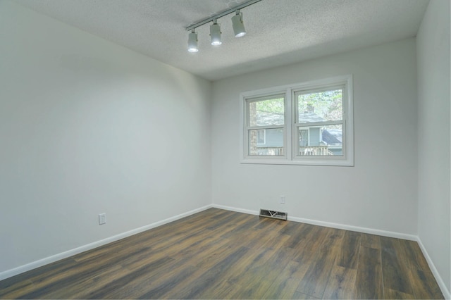 2401 Brookview Dr, Burnsville, MN 55337 - empty room featuring dark wood-style floors, track lighting, baseboards, and a textured ceiling