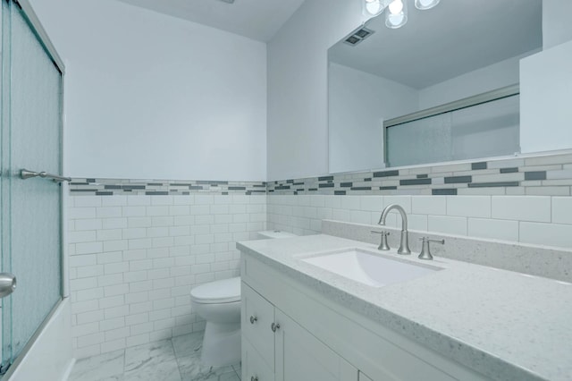 2401 Brookview Dr, Burnsville, MN 55337 - bathroom featuring a shower with shower door, marble finish flooring, toilet, tile walls, and vanity