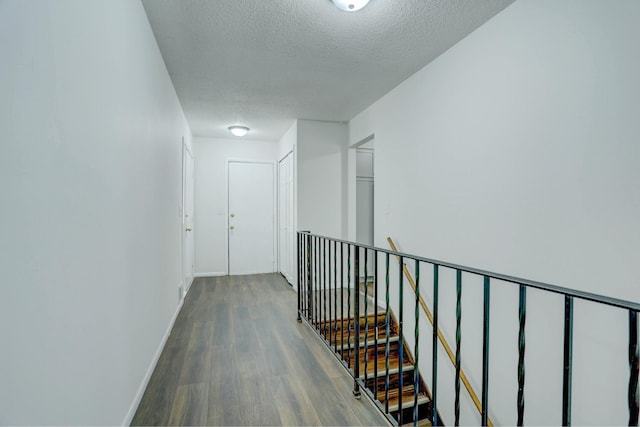 2401 Brookview Dr, Burnsville, MN 55337 - corridor featuring wood finished floors, a textured ceiling, an upstairs landing, and baseboards