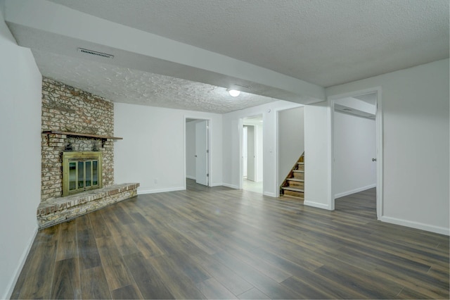 2401 Brookview Dr, Burnsville, MN 55337 - unfurnished living room with a textured ceiling, stairway, wood finished floors, baseboards, and a fireplace