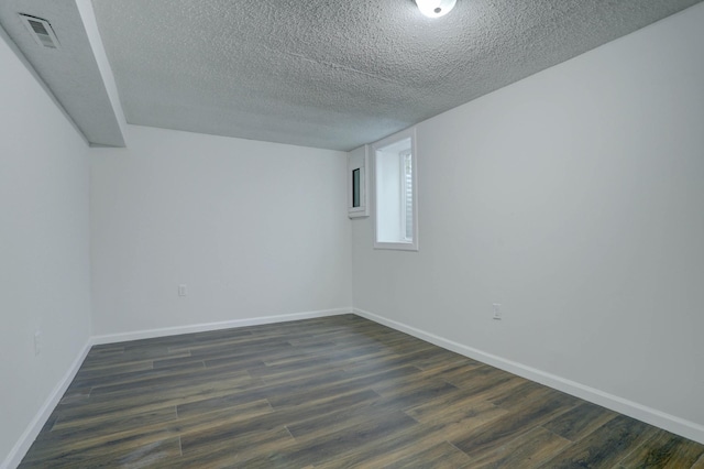 2401 Brookview Dr, Burnsville, MN 55337 - empty room featuring a textured ceiling, dark wood-type flooring, and baseboards