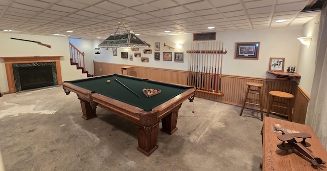 playroom with pool table, concrete flooring, and a wainscoted wall