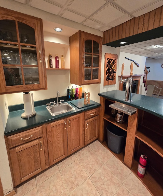 bar with light tile patterned floors, indoor wet bar, and a sink
