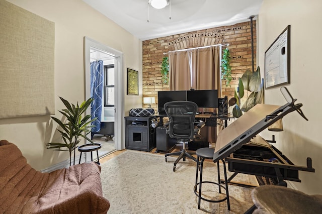 1204 Harmon Pl Unit 18, Minneapolis, MN 55403 - office featuring wood finished floors, brick wall, and ceiling fan
