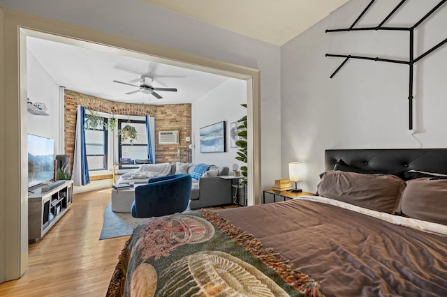 1204 Harmon Pl Unit 18, Minneapolis, MN 55403 - bedroom with light wood finished floors, a wall unit AC, and ceiling fan