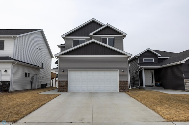 craftsman-style home featuring an attached garage, board and batten siding, brick siding, a front yard, and driveway