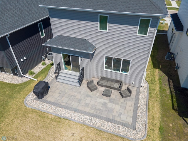 4964 Big Goose Ln S, Fargo, ND 58104 - back of property with entry steps, roof with shingles, a patio, and a yard