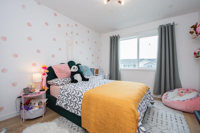 4964 Big Goose Ln S, Fargo, ND 58104 - bedroom with wood finished floors, vaulted ceiling, and baseboards