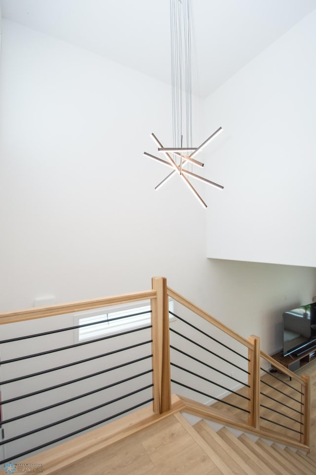 4964 Big Goose Ln S, Fargo, ND 58104 - stairs featuring a chandelier and wood finished floors