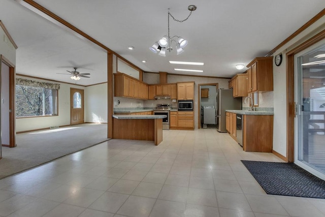 kitchen featuring crown molding, lofted ceiling, open floor plan, light countertops, and stainless steel appliances