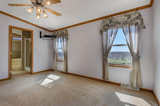 unfurnished bedroom featuring carpet floors, ornamental molding, baseboards, and visible vents